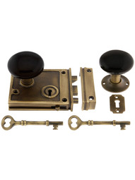 Solid Brass Horizontal Rim Lock Set with Black Porcelain Door Knobs.